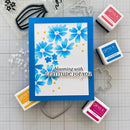 Card with blue floral design and text on a grid background with stamps and tools.