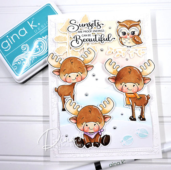 Card with cute moose illustrations and text, featuring Gina K. products.