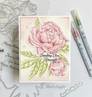 Card with pink roses and 'Sending You Strength' text, surrounded by stamping tools on a white background.