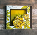 Decorative card with yellow roses and 'Happy Anniversary' text on a wooden background