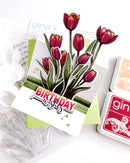 Card with tulip design and 'Birthday Wishes' text, surrounded by Gina K. products.