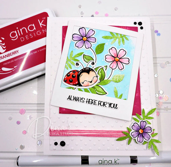 Card with ladybug and flowers design on a white background with 'gina k Design' products.