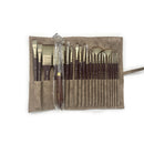Set of paintbrushes in a brown case on a white background