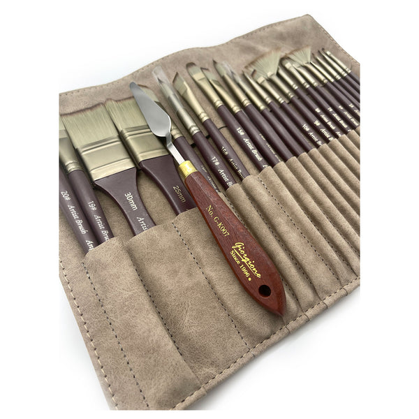 Set of paint brushes in a beige leather case on a white background