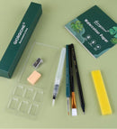 Art supplies including a sharpener, watercolor paper, brushes, and a pen on a green background.