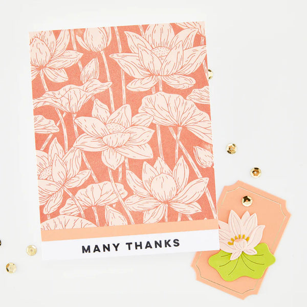 Floral patterned card with 'Many Thanks' text and decorative item on a white background