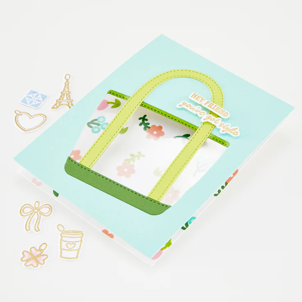 Children's handbag with floral pattern on a light blue card with decorative elements.