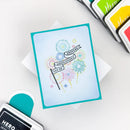 Colorful card with fireworks design on a white surface with stamping tools.