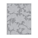 Decorative mat with white floral pattern on a gray background