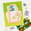 Card with a pink tote bag and keychain on a green background