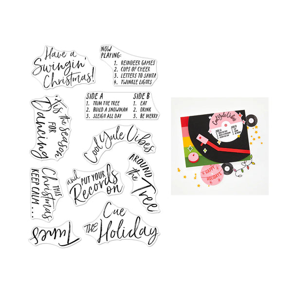 A sheet of holiday-themed temporary tattoos or decals on a white background, featuring various black script and block lettering designs like 'Have a Swingin' Christmas!' and 'Side A / Side B' lyrics, alongside a small preview of a decorated card with matching holiday graphics.