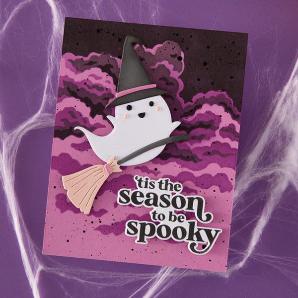 Halloween-themed card with a ghost and broom on a purple background