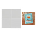 Set of white woven placemats with a decorative mat featuring bowls on a wooden surface.