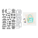 Set of metal stamps with various designs and text, next to a card with a printed design.