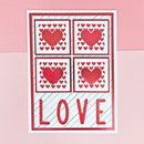 Card with red hearts and the word 'LOVE' on a pink background
