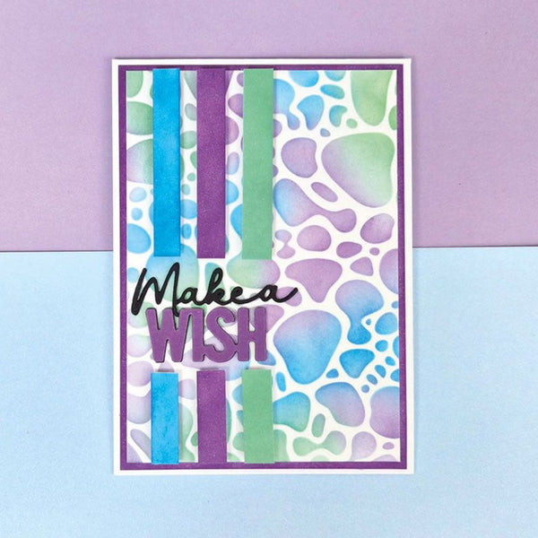 Colorful card with 'Make a Wish' text on a purple and blue background