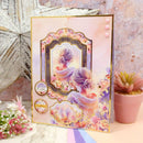 Decorative birthday card with a floral design and a woman's silhouette on a textured surface.
