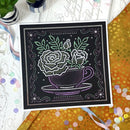 Decorative blackboard with a floral design of roses in a teacup on a colorful surface.