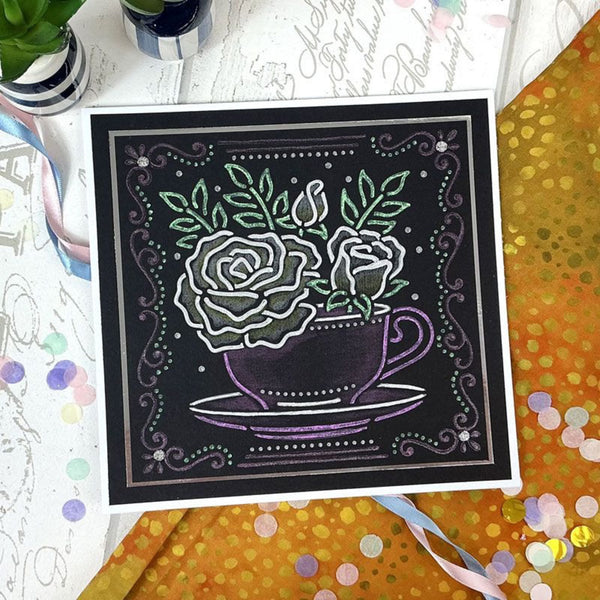 Decorative blackboard with a floral design of roses in a teacup on a colorful surface.