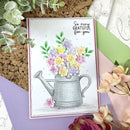 Greeting card with a watering can and flowers design, surrounded by floral elements.