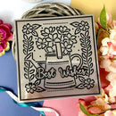 Decorative metal stencil with floral design and 'Best Wishes' text on a colorful background.
