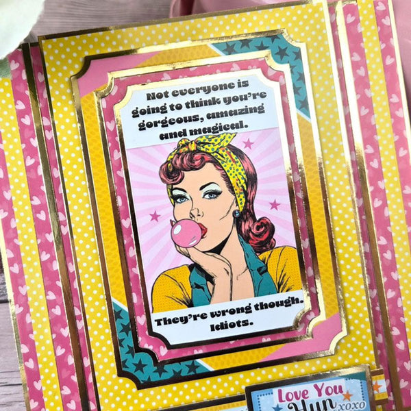Card with a graphic of a woman blowing bubble gum, surrounded by colorful text and patterns.