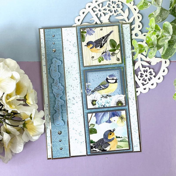 Decorative card with bird illustrations on a purple surface with flowers and decorative elements.