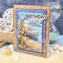 Nautical-themed birthday card with a boat and seagull design, surrounded by beach decor.