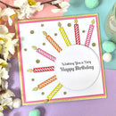 Birthday card with colorful candles and 'Wishing You a Very Happy Birthday' text, surrounded by flowers and decorative items.