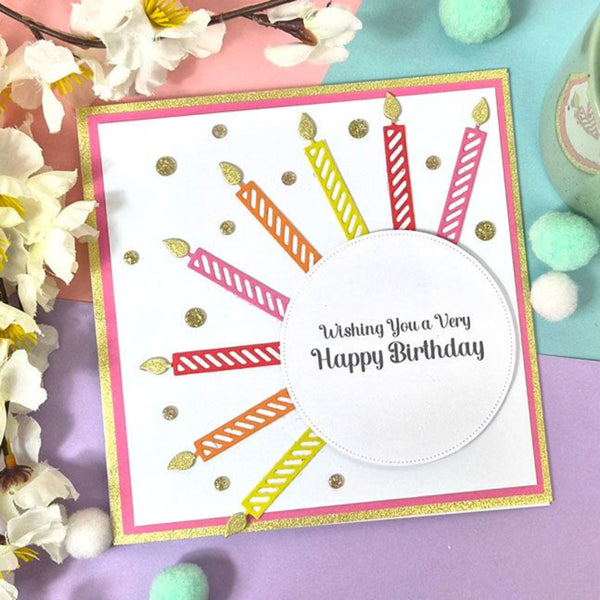Birthday card with colorful candles and 'Wishing You a Very Happy Birthday' text, surrounded by flowers and decorative items.