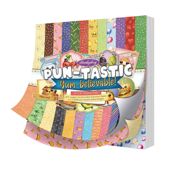 Colorful paper pad packaging with various patterns and cartoon characters on a white background