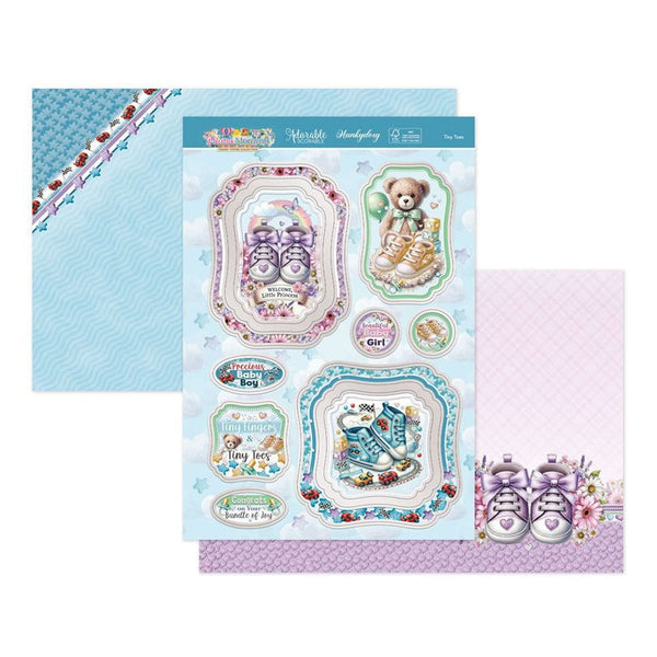 Decorative paper with baby-themed designs including teddy bears, shoes, and text on a blue and purple background.