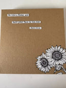 Brown paper with black and white sunflower illustration and motivational quote on a white background