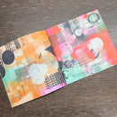 Two colorful patterned cards on a wooden surface