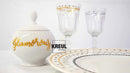 White ceramic jar with gold text, two glasses, and a plate on a white background with Kreul branding.