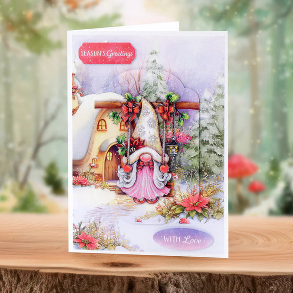 Christmas card with a fairy in front of a snowy house, featuring 'Season's Greetings' and 'With Love' text.