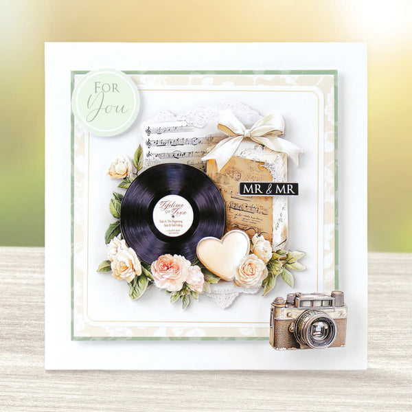 Decorative card with vinyl record, flowers, and vintage camera on a gradient background