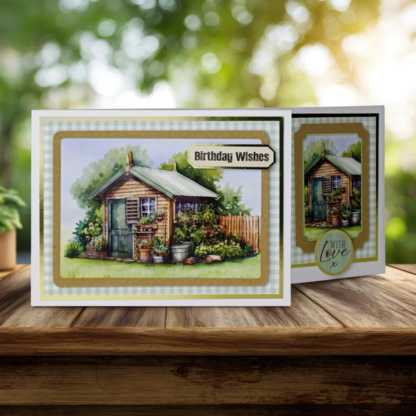 Greeting card with a garden shed illustration and 'Birthday Wishes' text on a wooden surface.