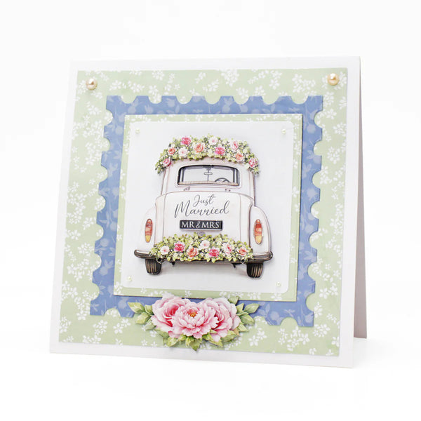 Wedding card with a vintage car and floral decorations on a decorative border.