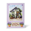 Greeting card with a garden shed and potted plants on a purple polka dot background.