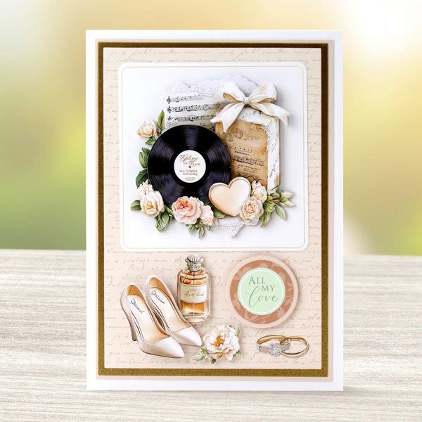 Greeting card with vinyl record, flowers, high heels, and other decorative elements on a textured surface.