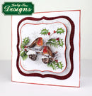 Decorative plate with winter scene featuring birds and holly, branded 'Katy Sue Designs'.