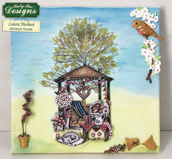 Card with a treehouse, flowers, and bird design by Katy Sue Designs on a blue background.