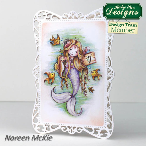 Card with a mermaid design featuring fish and a decorative frame, branded with Katy Sue Designs.