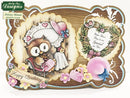 Card with owl design and decorative elements on a wooden frame background