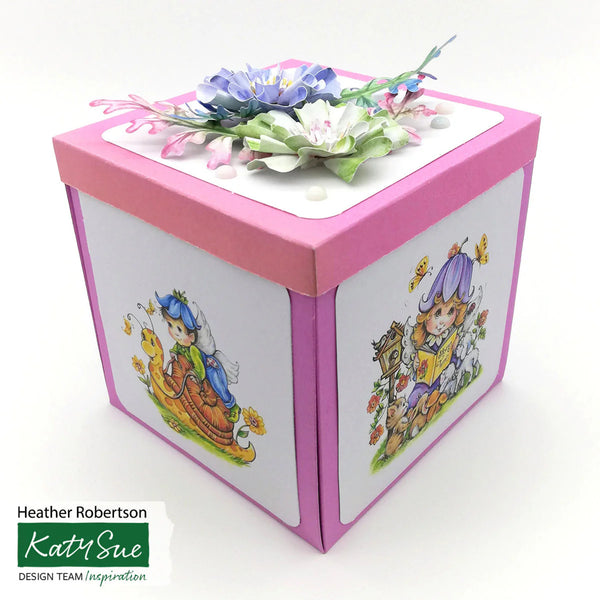 Decorative box with floral top and character illustrations on a white background, featuring Katy Sue branding.