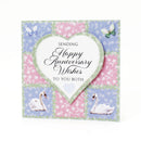 Anniversary card with swans, butterflies, and floral patterns on a white background