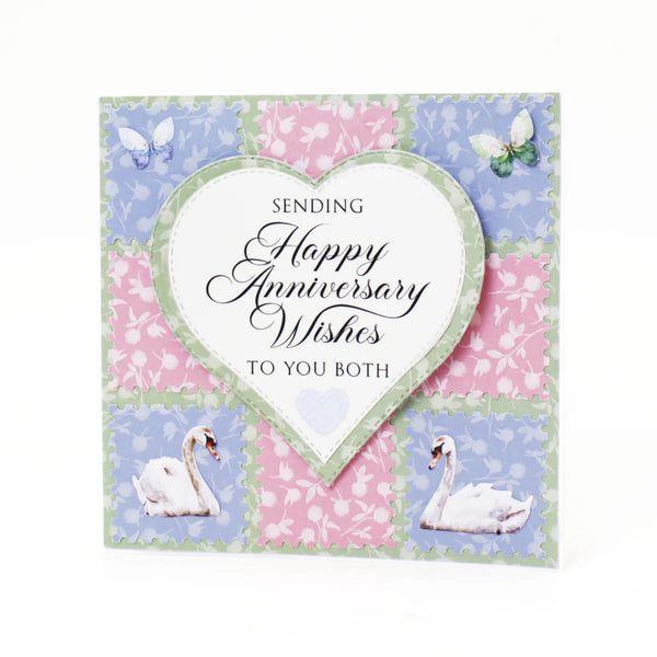 Anniversary card with swans, butterflies, and floral patterns on a white background