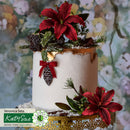 Decorative cake with red flowers, pinecones, and greenery against a floral background