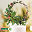 Decorative wreath with greenery and berries on a blurred background, featuring the Katy Sue Flower Co. logo.